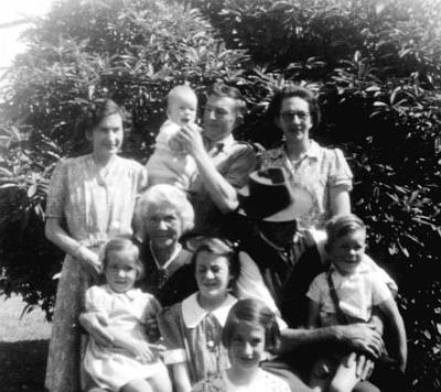 26-MILLER_Group.jpg - L to R back Jean Venables nee Miller, Doug Miller
holding Bruce Miller (8 months), Gwenyth Graham Miller
nee Stewart, middle Ann Venables on Elizabeth Miller
nee Gichard knee, Judith Stewart, Graham Miller on
John Graham Miller's knee Front Elisabeth Gael Pye nee
Stewart Christmas 1948 at 10 Totara St, Masterton